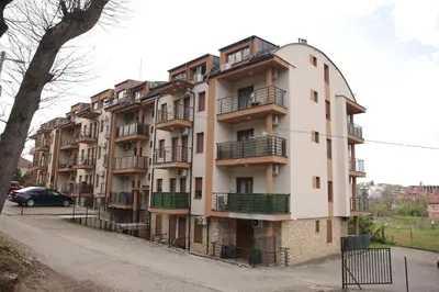 a building with balconies on the side of it at Apartman Lena in Vrnjačka Banja