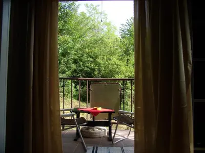 a room with a table and a chair on a balcony at Panorama 5 in Soko Banja