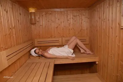 a woman is laying in a sauna at Hotel 