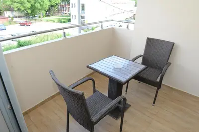a table and chairs on a balcony with a view at Harmony Bed and Breakfast in Vranje