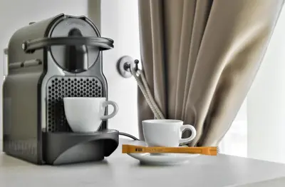 a coffee maker and two cups on a table at Harmony Bed and Breakfast in Vranje