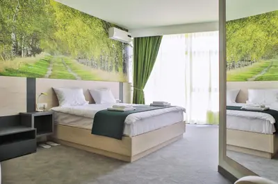 a bedroom with two beds and a large window at Harmony Bed and Breakfast in Vranje
