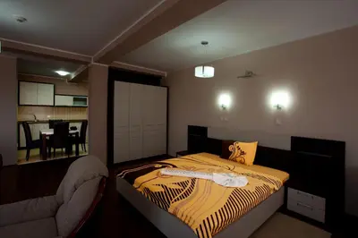 a bedroom with a bed and a chair in it at Guesthouse Vitez in Vranje