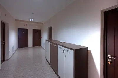 a hallway with a counter and a room with doors at Guesthouse Vitez in Vranje