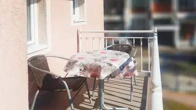 a table with a cloth on a chair on a balcony at Apartments Petkovic in Soko Banja