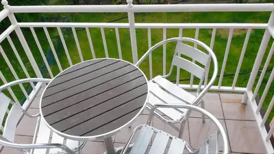 a table and chairs sitting on a balcony at Apartments Petkovic in Soko Banja