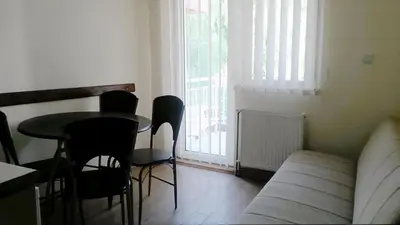 a living room with a table and chairs and a couch at Apartments Petkovic in Soko Banja