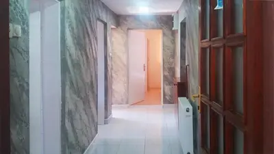 a hallway with a door and a tile floor at Apartments Petkovic in Soko Banja