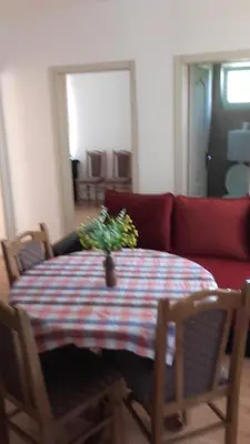 a living room with a table and a red couch at Apartment Pavlovic in Soko Banja