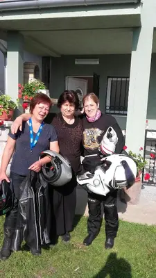 a group of three women standing next to a motorcycle at Apartment Pavlovic in Soko Banja