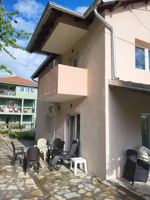 a patio outside of a building with chairs and tables at Apartment Pavlovic in Soko Banja