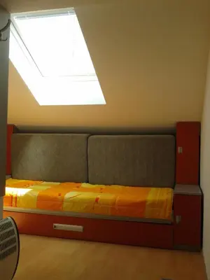 a bedroom with a bed with a skylight at Studio Pinos in Soko Banja