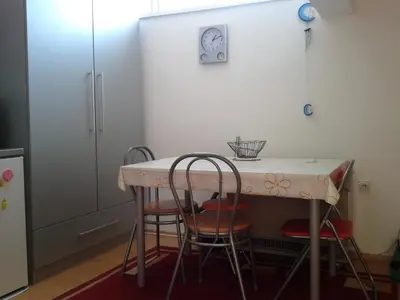 a kitchen with a table and four chairs at Studio Pinos in Soko Banja