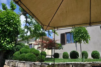an umbrella in front of a house at Guesthouse Djurić in Negotin