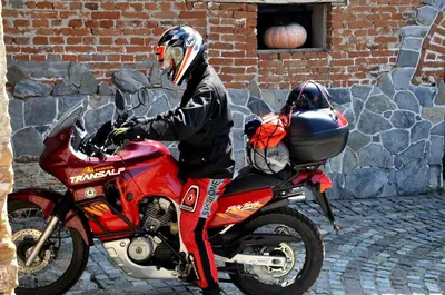 a man is sitting on a red motorcycle at Guesthouse Djurić in Negotin