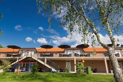 a building with umbrellas on top of it at Apartmani 