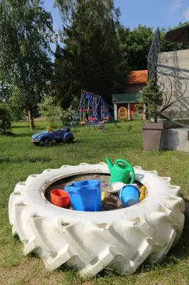 a toy sandbox in the grass with a playground at Apartmani 