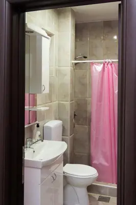 a bathroom with a toilet and a sink and a shower at Apartmani 