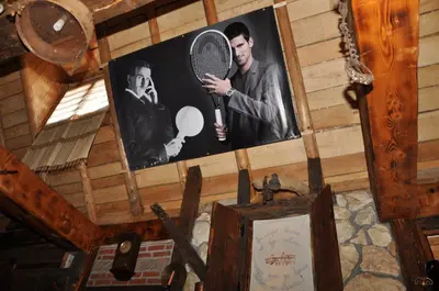 a picture of a man holding a tennis racket at Inn Cakmara in Raška