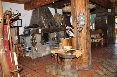 a room with a fireplace and a table in a room at Inn Cakmara in Raška