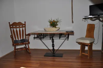a table with a potted plant and two chairs at Inn Cakmara in Raška