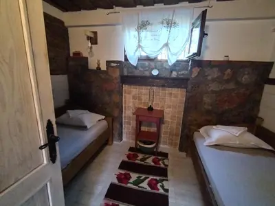 a room with two beds and a fireplace at Seosko turističko domacinstvo Imunsan in Niš