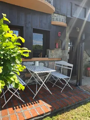 two chairs and a table in front of a building at Seosko turističko domacinstvo Imunsan in Niš