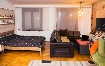 a living room with a bed and a couch at Apartment Aleksija in Niš