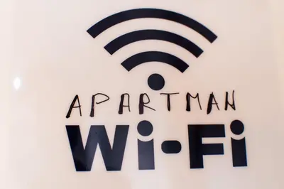 a sign for the american wifi company at Apartment Aleksija in Niš