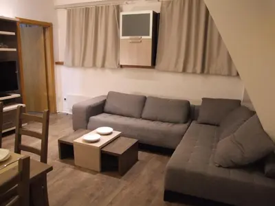 a living room with a couch and a table at Apartments Mitic in Kopaonik