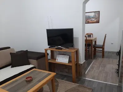 a living room with a couch and a television on a table at Vikendica RTANJ in Rtanj