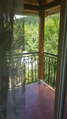 a screened porch with a view of a golf course at Apartmani V&F in Vrnjačka Banja
