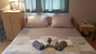 a bedroom with a bed with two towels on it at Apartmani V&F in Vrnjačka Banja