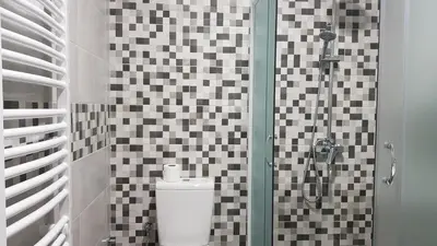 a bathroom with a toilet and a glass shower at Apartmani V&F in Vrnjačka Banja