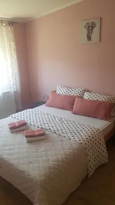 a bedroom with a large bed with two pillows on it at Apartmani V&F in Vrnjačka Banja