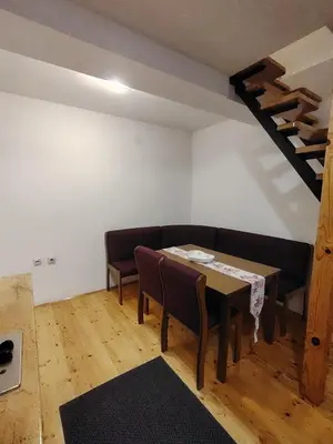 a living room with a couch and a table at Studio Apartman Lenka in Soko Banja