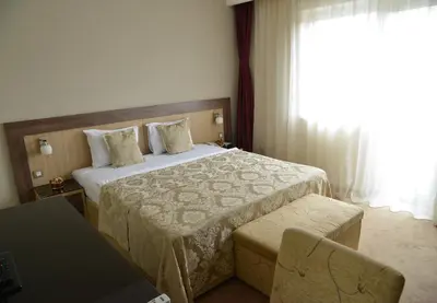 a hotel room with a bed and a window at Hotel Tami Residence in Niš