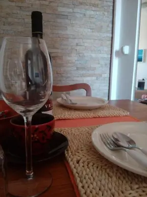 a wine glass sitting on top of a table at Apartment Boris in Niš