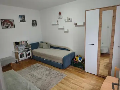 a small bedroom with a bed and a staircase at Planinska kuća Vladanka - planina Goč - banjska strana - preko puta ski staze in Biserske Kuće
