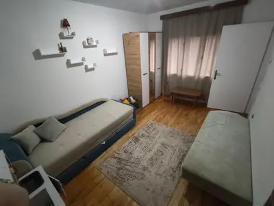a small room with a bed and a couch at Planinska kuća Vladanka - planina Goč - banjska strana - preko puta ski staze in Biserske Kuće