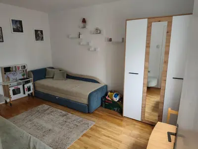 a small bedroom with a bed and a mirror at Planinska kuća Vladanka - planina Goč - banjska strana - preko puta ski staze in Biserske Kuće