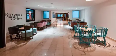 a restaurant with chairs and tables in a room at Hotel Putnik Kopaonik in Kopaonik