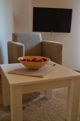 a bowl of fruit sitting on a coffee table at B&B Alex18 in Niš