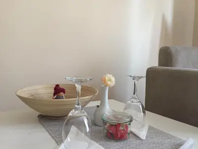 a table with two wine glasses and a bowl at B&B Alex18 in Niš