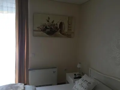 a bedroom with a bed and a picture on the wall at B&B Alex18 in Niš