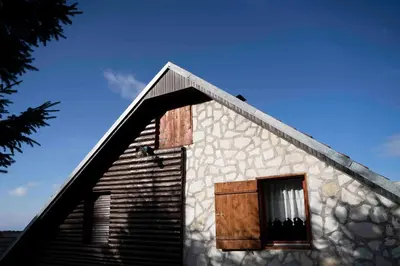 a house with a window on the side of it at Apartments Holiday Home Srce in Kopaonik