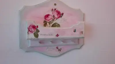 a shelf with pink flowers and butterflies on it at Apartments Holiday Home Srce in Kopaonik