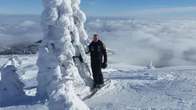 a man standing on top of a snow covered mountain at Kuca za odmor ''Djurovic'' in Kopaonik