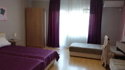 a hotel room with a bed and a window at Apartments Tatjana in Jagodina