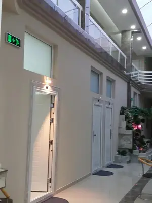 a hallway of a building with a door and stairs at Atina Lux Hostel in Leskovac